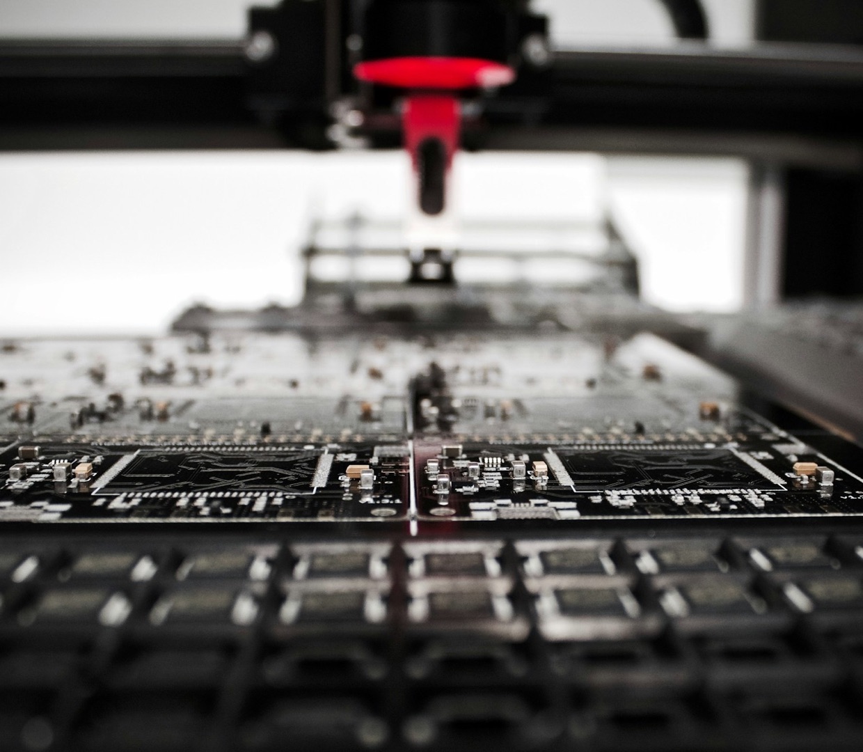 A real machine placing parts on a panel of circuit boards